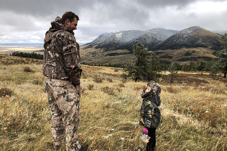 Tom Duffy taking his child hunting in a grassy Montana field